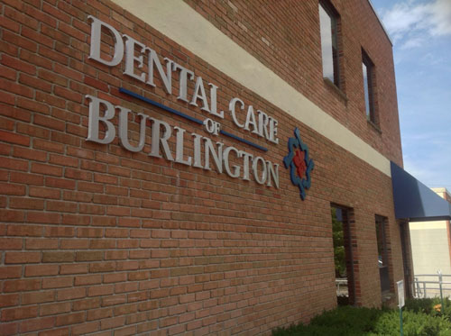 Dental Care of Burlington logo on the exterior of our Burlington, MA office.