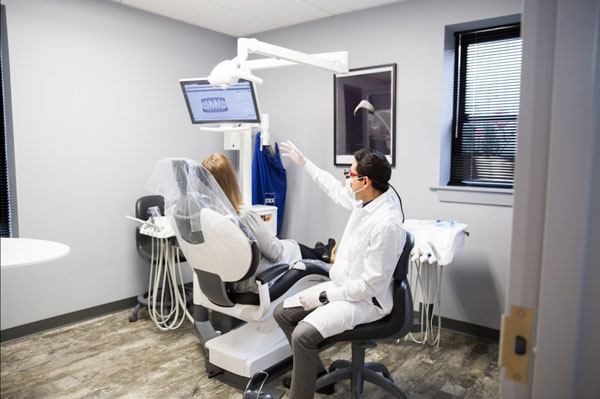 Dr. Patrick reviewing x-rays with a patient at Dental Care of Burlington in Burlington, MA.