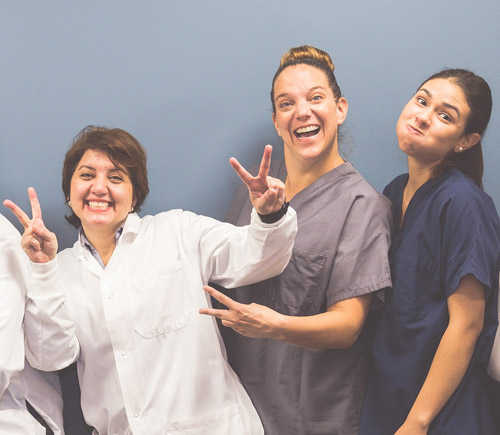 Dr. Shaibani and the team having fun and striking a pose, at Dental Care of Burlington in Burlington, MA.