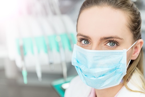 Dentist wearing a disposable medical face mask