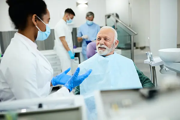 A patient discussing the dental implant procedure with his doctor A patient discussing the dental implant procedure with his doctor