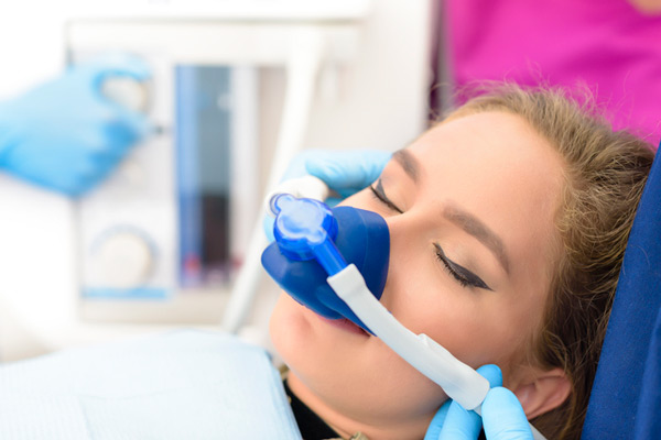 Sedated woman in dental chair