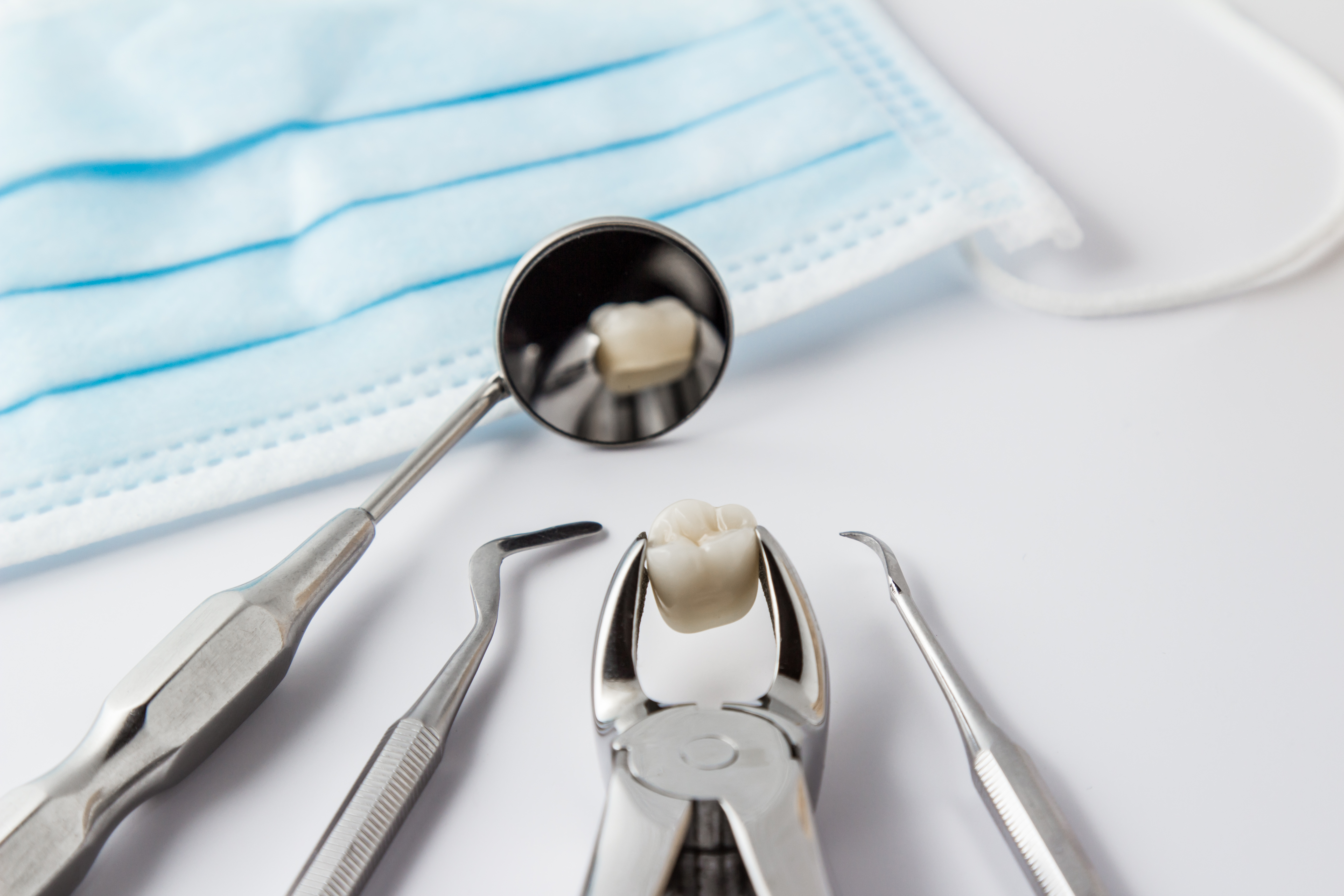 Dental extraction tools and wisdom tooth at Dental Care of Burlington in Burlington, MA